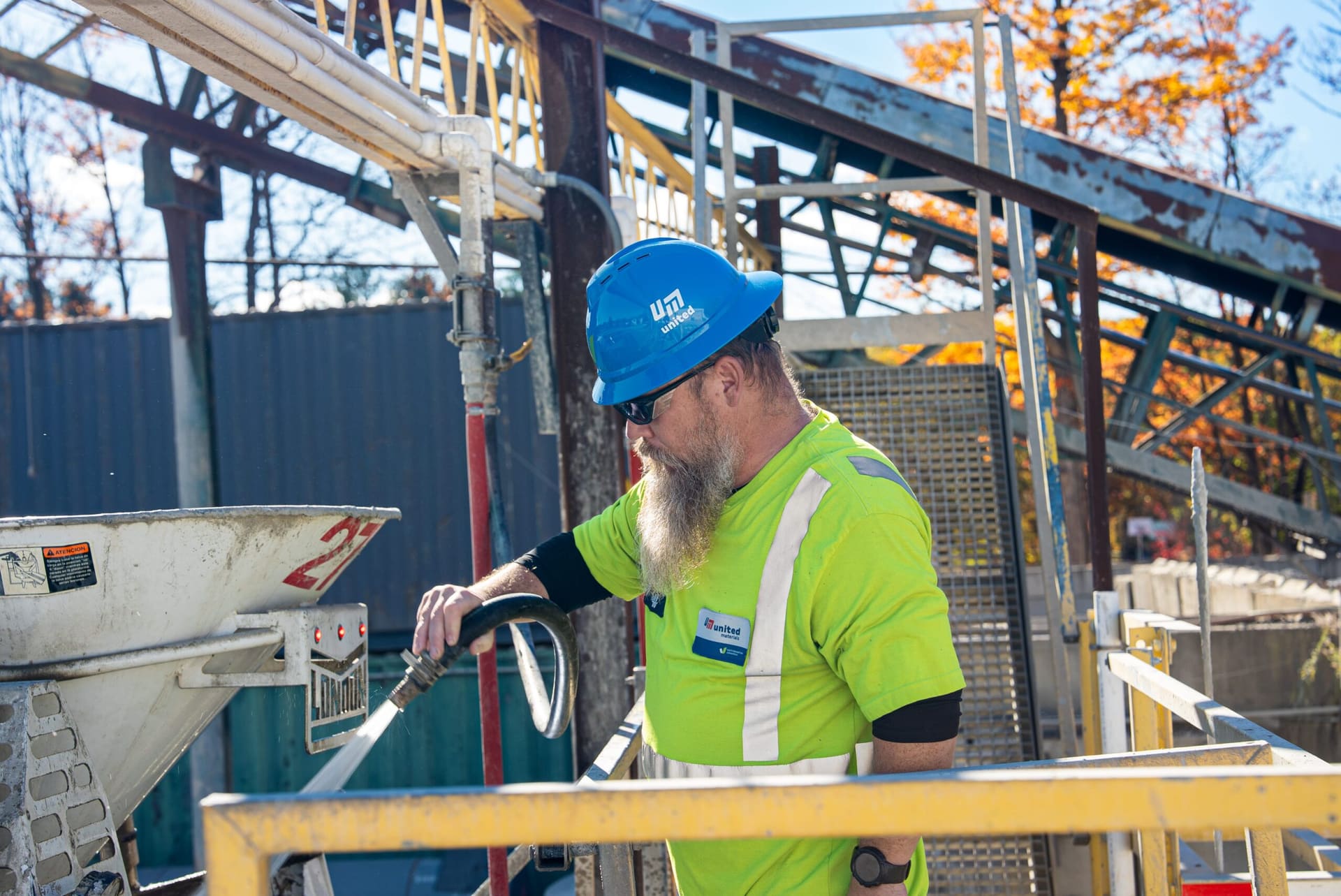 SureFlow - United Materials worker rinsing a mixer truck hopper at the plant loading=