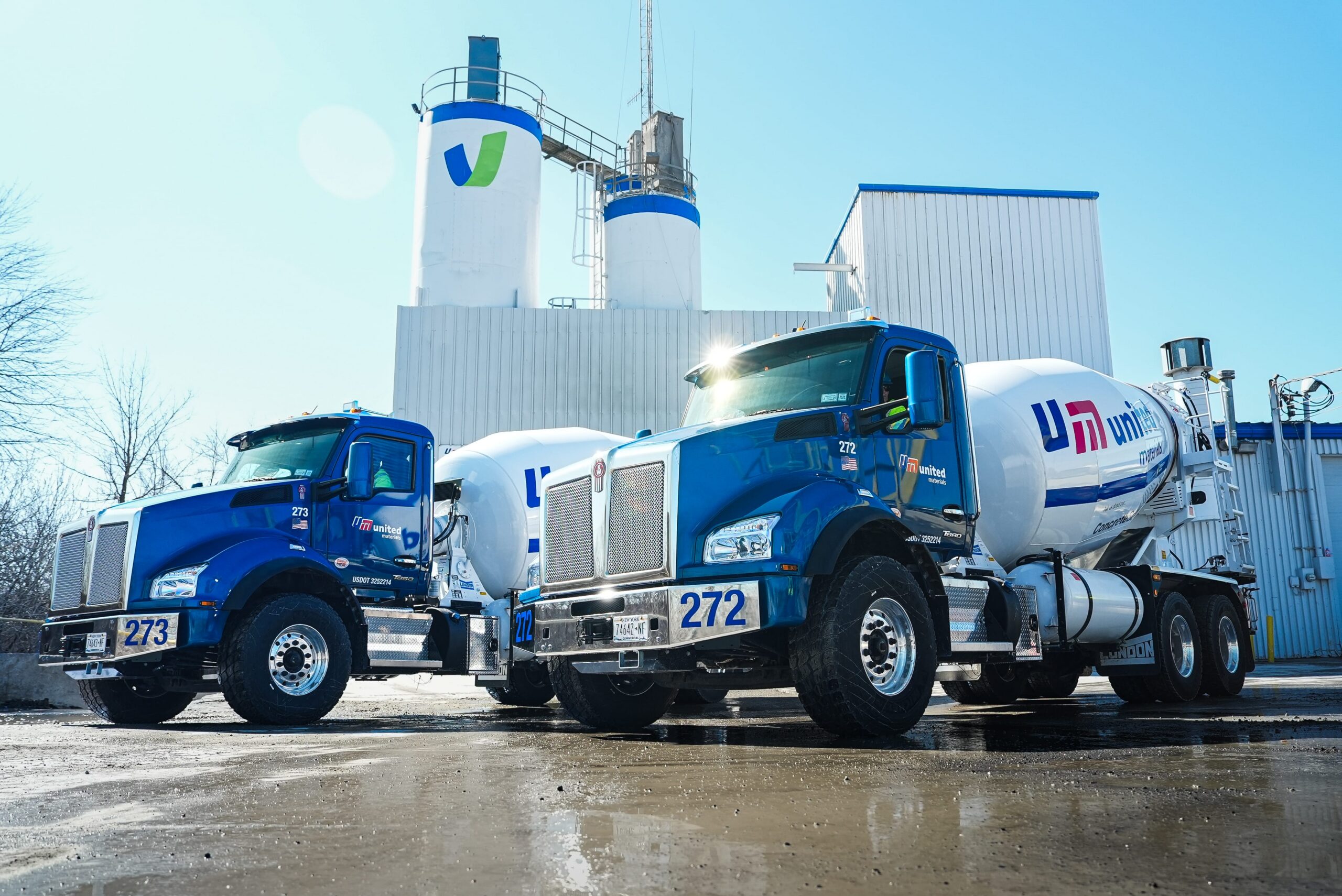 two United Materials trucks standing in front of a concrete plant in Western New York.